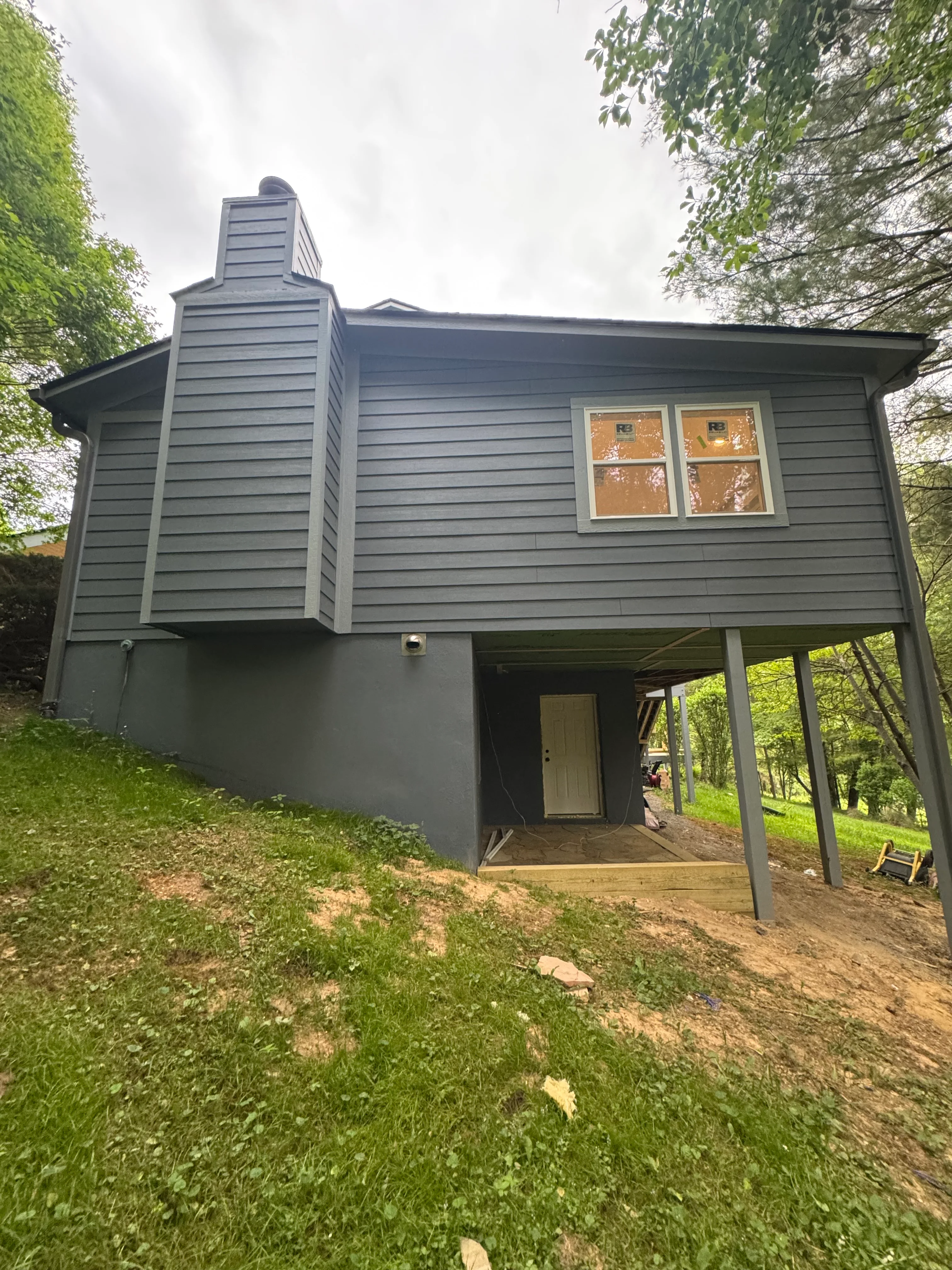 A newly completed room addition on a single-family home in Cherryville, NC, showing matched siding, a tied-in roofline, and a finished exterior that blends with the original structure. The addition extends the rear of a traditional ranch-style home on a residential lot.